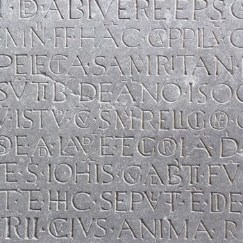 An ancient latin inscription on the marble slab.