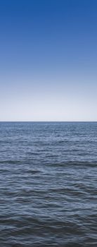 Front view of the sea with blue sky in the background.