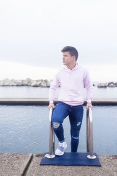 Young teenager standing on promenade while looking away