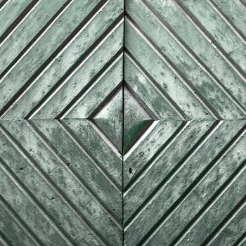 Details of an old wooden door with diamond pattern.