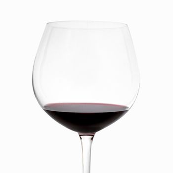 Vertical shot of a glass of red wine on white background.