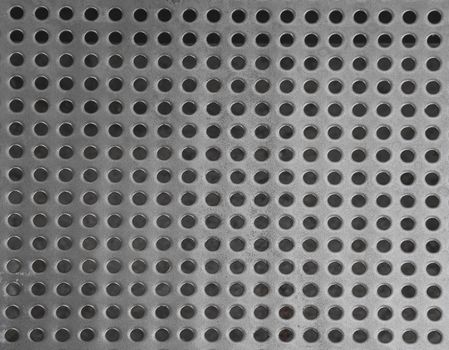 iron stainless steel grating with small regular circle shaped holes black and white geometric background