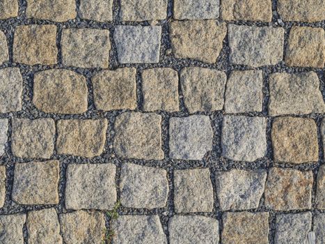 Prague cobblestone gray beige paving stone square background