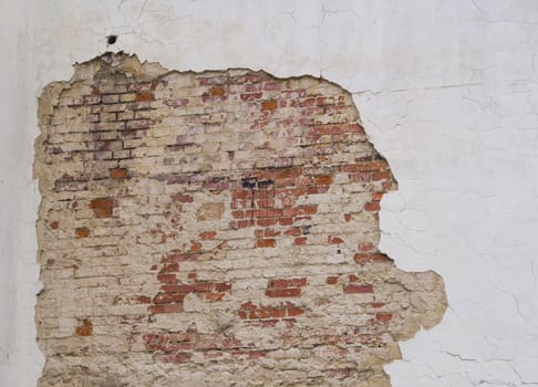white cracked wall with peeling plaster with red brick grunge vintage background