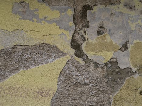 yellow plaster peeling cracked facade abstract background