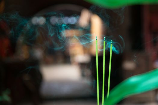 Incense burning in temple and shrine. Incense is a part of Vietnamese life and will be found in homes and religious places. Called huong or nhang and sticks are usually burned in odd numbers.High quality photo