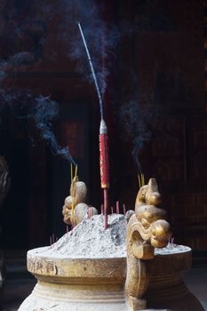 Incense burning in temple and shrine. Incense is a part of Vietnamese life and will be found in homes and religious places. Called huong or nhang and sticks are usually burned in odd numbers.High quality photo