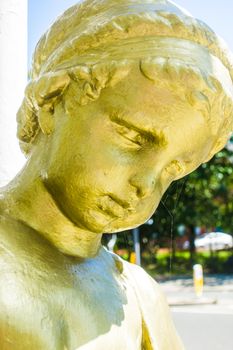 Close up view of a golden angel or cherub statue