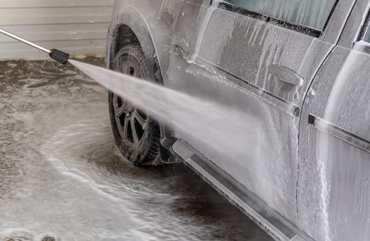 a closeup view of process of indoor wet car washing.