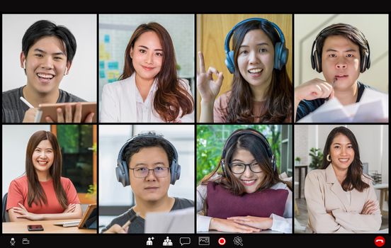 Asian Business people meeting and voting with teamwork colleague in video call conference screen when Covid-19 pandemic,Coronavirus outbreak,online meeting,Social distancing and new normal concept