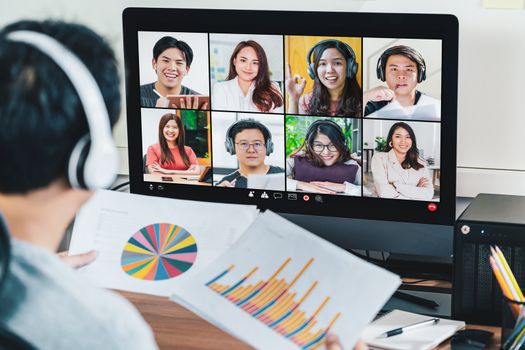 Rear view of Asian businessman working and online meeting via video conference with colleague and team building when Covid-19 pandemic,Coronavirus outbreak,Social distancing and new normal concept