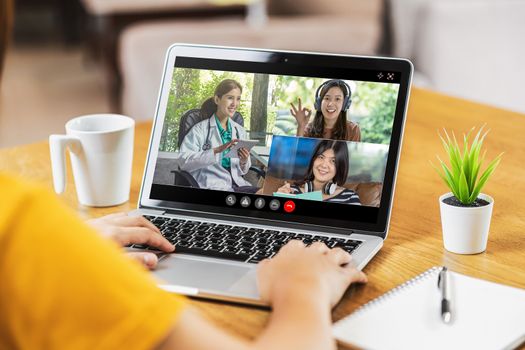 Rear View of Asian Business woman discussing with doctor and teamwork colleague to follow up sickness in video conference when Coronavirus outbreak, Covid-19 pandemic,online meeting and new normal