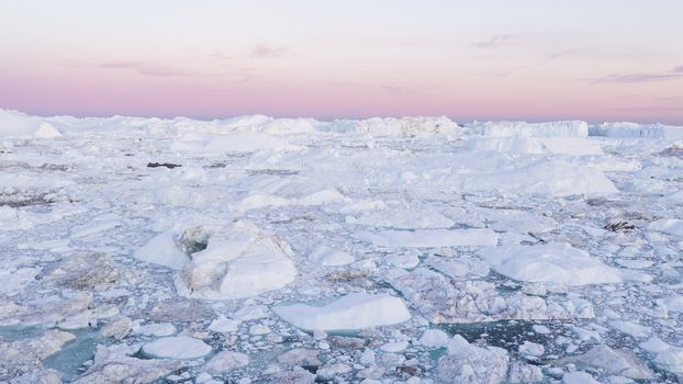 Drone photo of Iceberg and ice from glacier in arctic nature landscape on Greenland. Aerial photo drone photo of icebergs in Ilulissat icefjord. Affected by climate change and global warming.