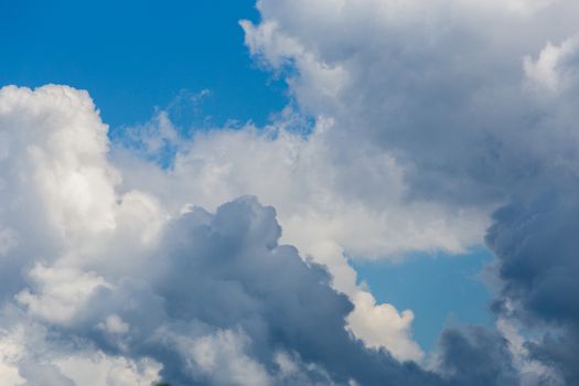 Regular spring clouds on blue sky at daylight in continental europe. Close shot wit telephoto lens