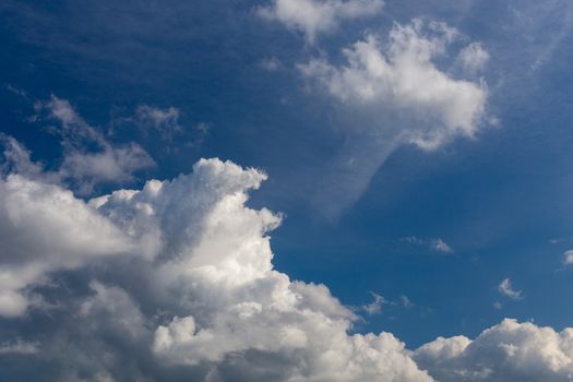 Regular spring clouds on blue sky at daylight in continental europe. Close shot wit telephoto lens and circular polarizing filter.