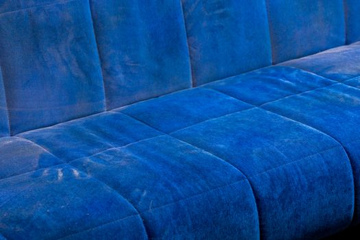 dusty blue sofa surface with palm prints closeup with selective focus.