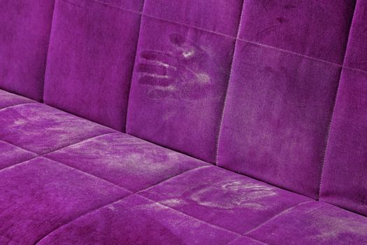 dusty pink sofa surface with palm prints closeup with selective focus.