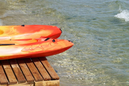 two kayaks on a wooden pier near the sea close up