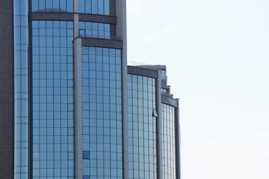 modern glass facade of a skyscraper against the sky, copy space