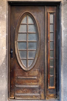 vintage entrance wooden brown door with glass close up