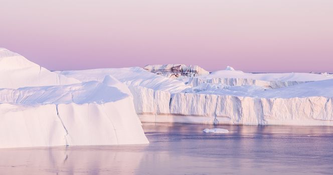 Climate Change. Iceberg and ice from glacier in arctic nature landscape on Greenland. Aerial image drone footage of icebergs in Ilulissat icefjord. famously affected by and global warming.