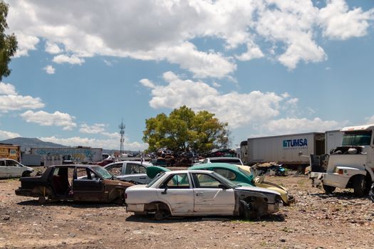 Old damaged cars on the junkyard waiting for recycling in Mexico City. Mexico