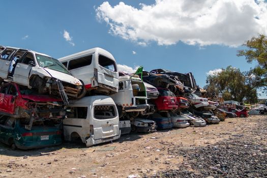 Old damaged cars on the junkyard waiting for recycling in Mexico City. Mexico