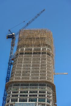 Construction of skyscrapers under blue sky close-up
