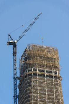 Construction of skyscrapers under blue sky close-up