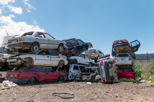 Old damaged cars on the junkyard waiting for recycling in Mexico City. Mexico