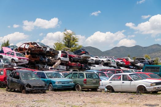 Old damaged cars on the junkyard waiting for recycling in Mexico City. Mexico