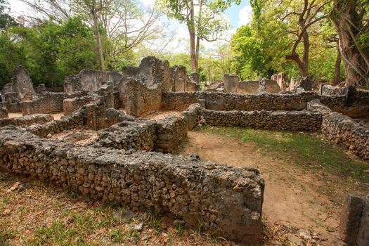 Ruins of ancient african city Gede (Gedi) in Watamu, Kenya with trees and sky in background.