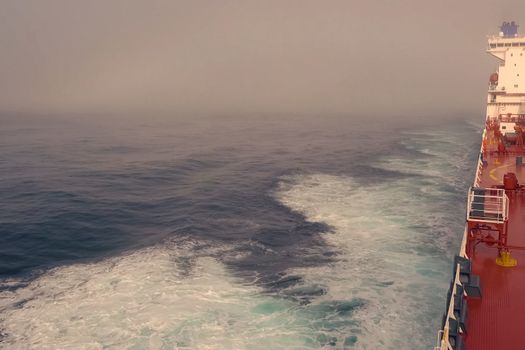 The feed of a ship sailing in the Arctic. Landscape of the Arctic from the deck of the tanker.