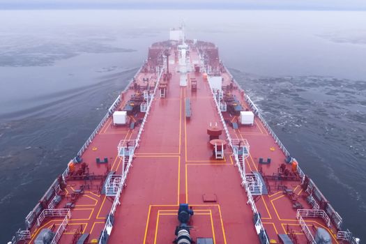 The feed of a ship sailing in the Arctic. Landscape of the Arctic from the deck of the tanker.