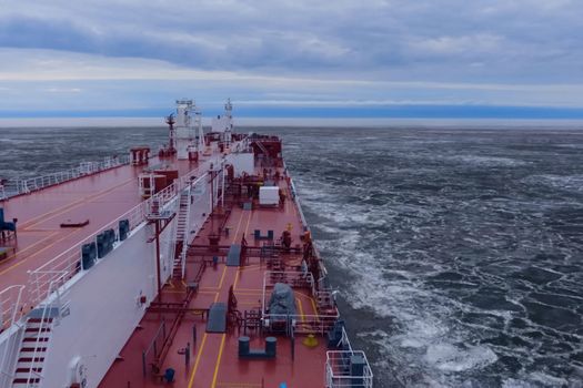 The feed of a ship sailing in the Arctic. Landscape of the Arctic from the deck of the tanker.