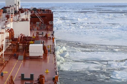 The feed of a ship sailing in the Arctic. Landscape of the Arctic from the deck of the tanker.