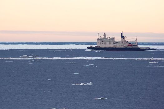 The ship sails among the Arctic ice.