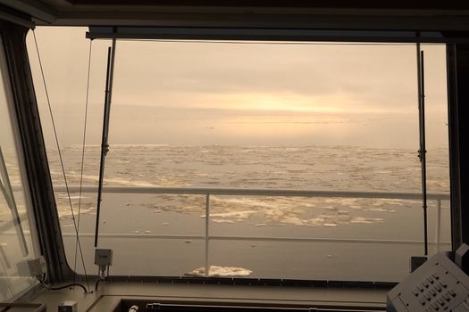 The Arctic landscape of the Arctic Ocean. Ice and cold. The Arctic landscape is from the tanker's cabin control.