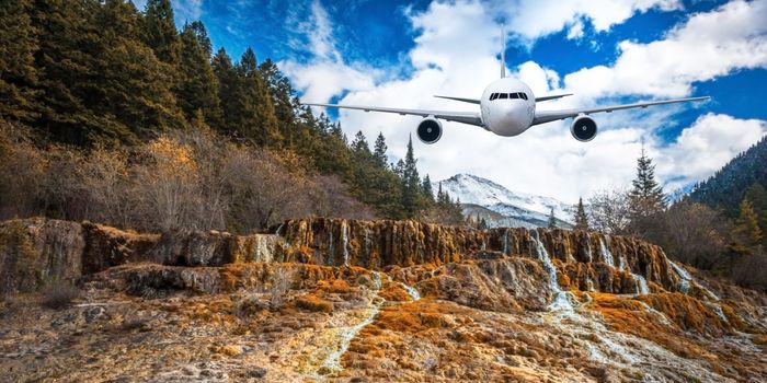 Airplane frying over the Snow Mountain background