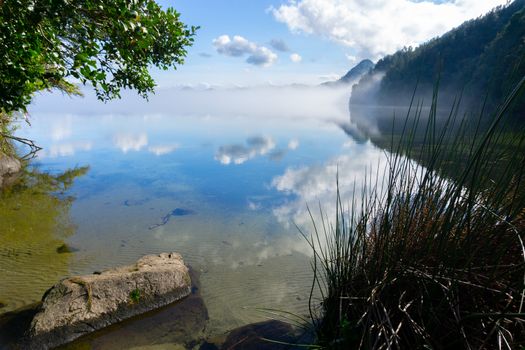 Scenic lake landscape as mist rises over Lake Okareka New Zealand.