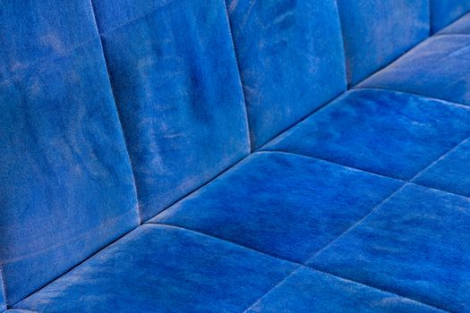 dusty blue sofa surface with palm prints closeup with selective focus.