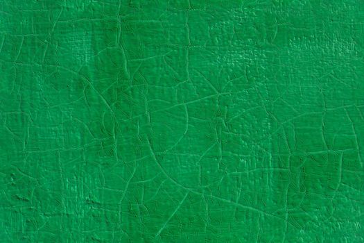 thick fresh green oil paint on flat steel surface seamless texture with old cracks under it.