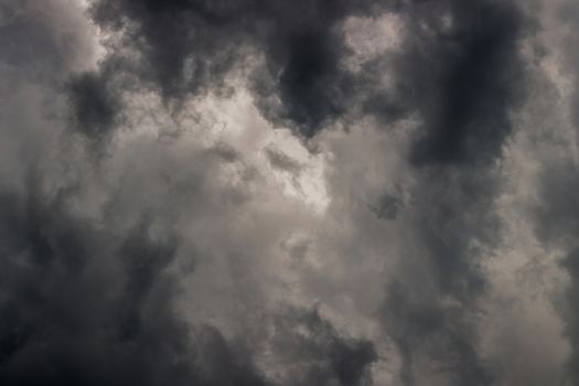 gray incoming storm clouds dark closeup backdrop, captured on 100 mm telephoto lens