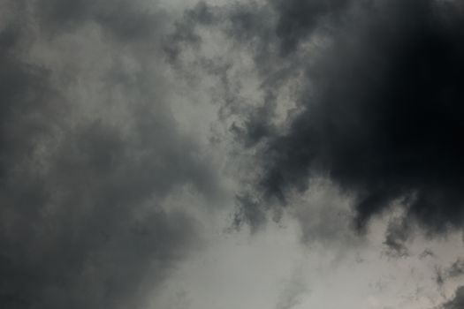 gray incoming storm clouds dark closeup backdrop, captured on 100 mm telephoto lens