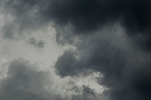 gray incoming storm clouds dark closeup backdrop, captured on 100 mm telephoto lens