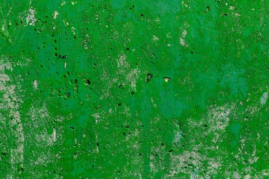 monocolor green painted flat concrete surface closeup texture.