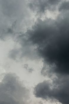 gray incoming storm clouds dark closeup backdrop, captured on 100 mm telephoto lens