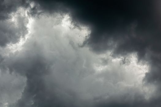 gray incoming storm clouds dark closeup backdrop, captured on 100 mm telephoto lens