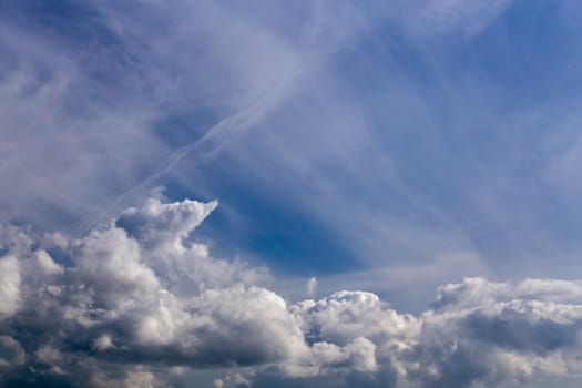 mixed cumulus and feather clouds closeup telephoto shot with polarizing effect