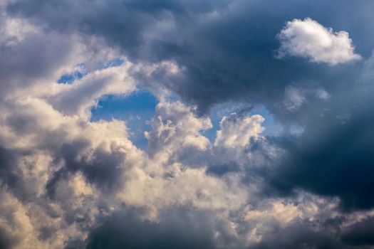 incoming shattered storm close-up clouds at march daylight in continental europe.